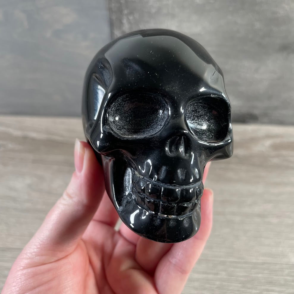 Large black obsidian crystal skull carving with polished finish