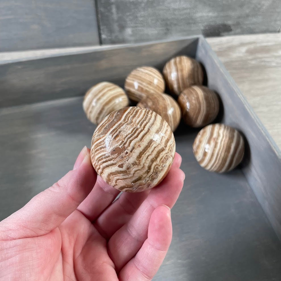 Polished banded Aragonite sphere for Reiki shops crystal stores and collectors