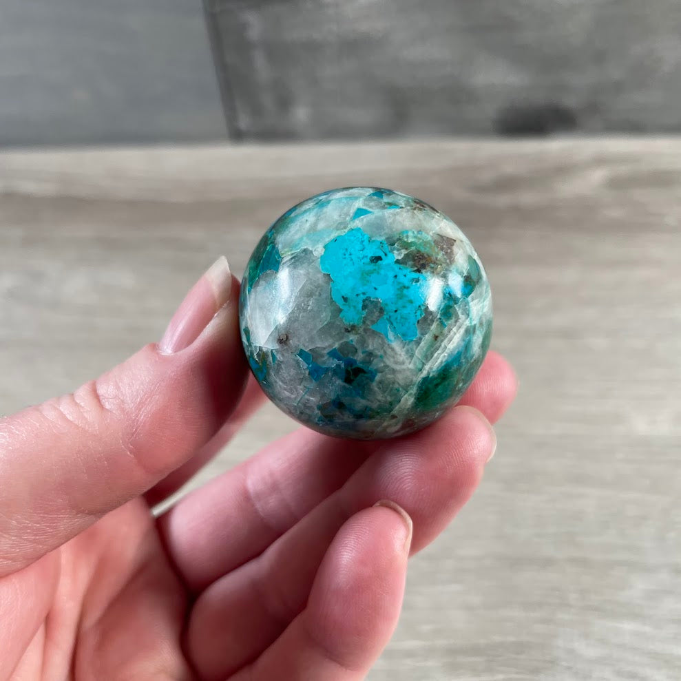 Smooth polished chrysocolla crystal ball with natural mineral patterns