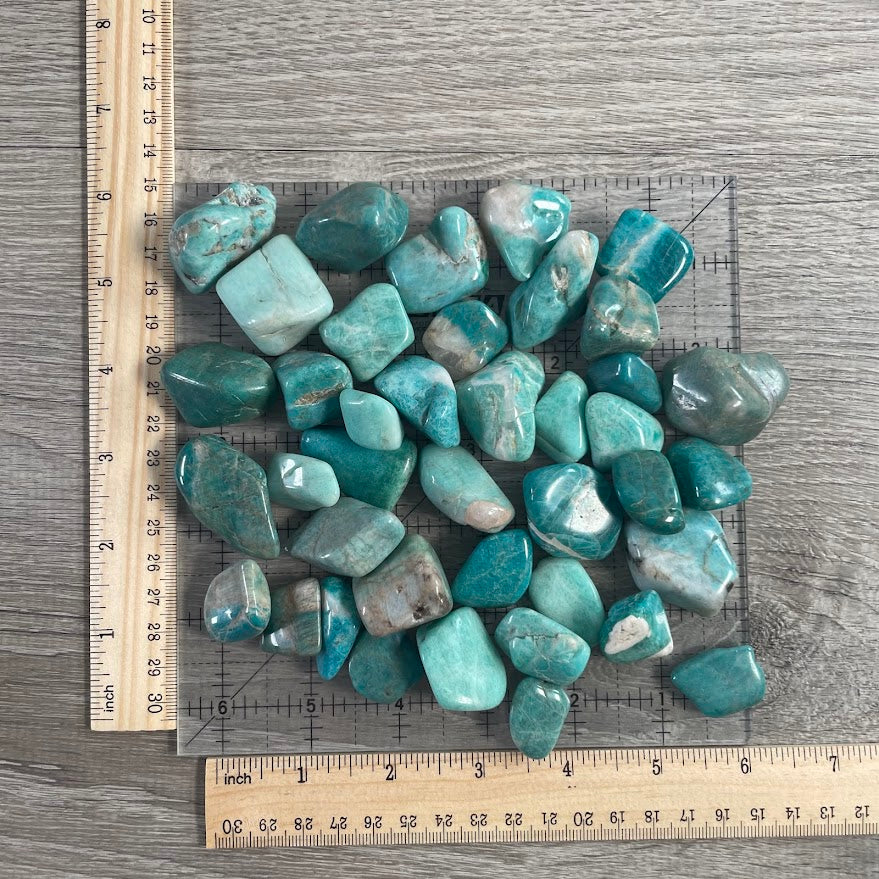 Polished Amazonite tumbled gemstones sold by the pound for wholesale crystal shops, gift stores, and metaphysical retailers