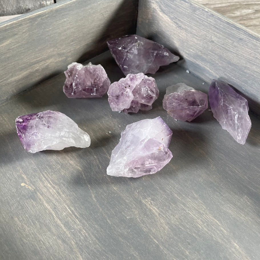 Rough purple amethyst quartz crystals with natural formations and varied sizes for bulk resale