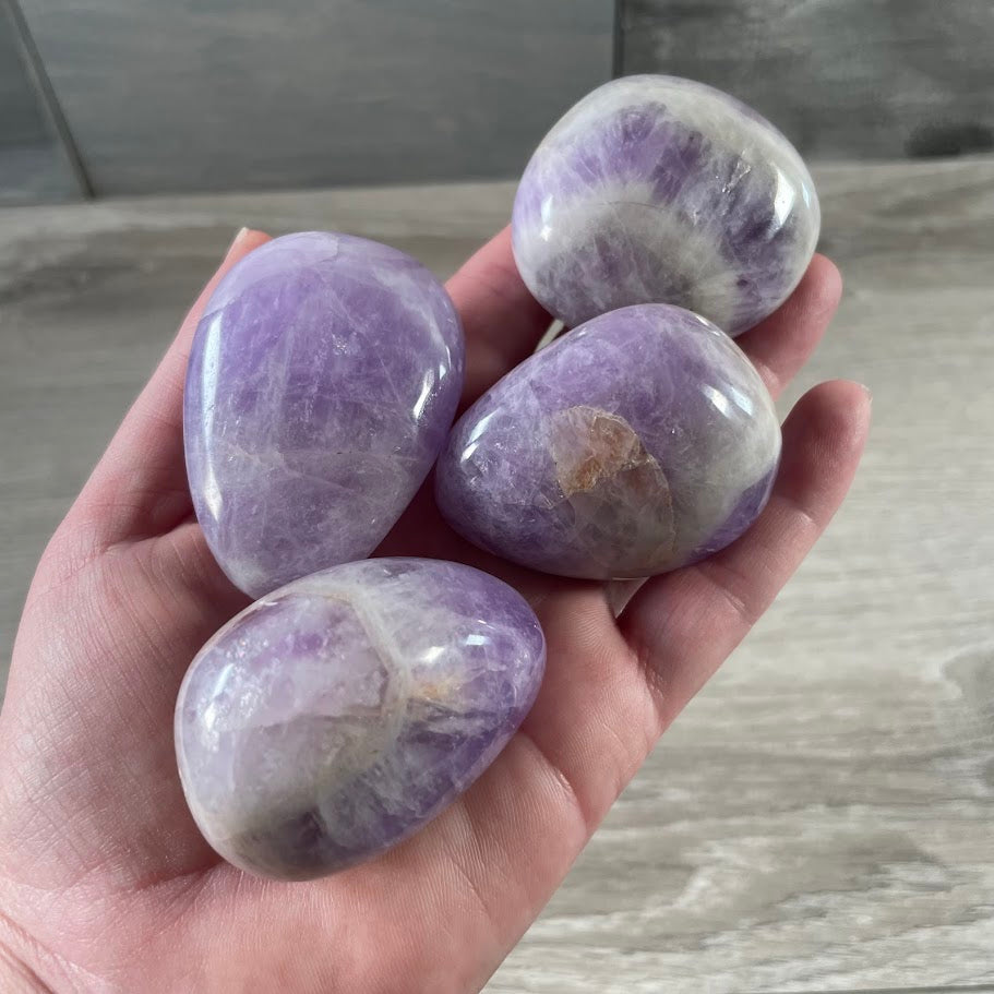 Wholesale amethyst crystal palm stones sold by weight
