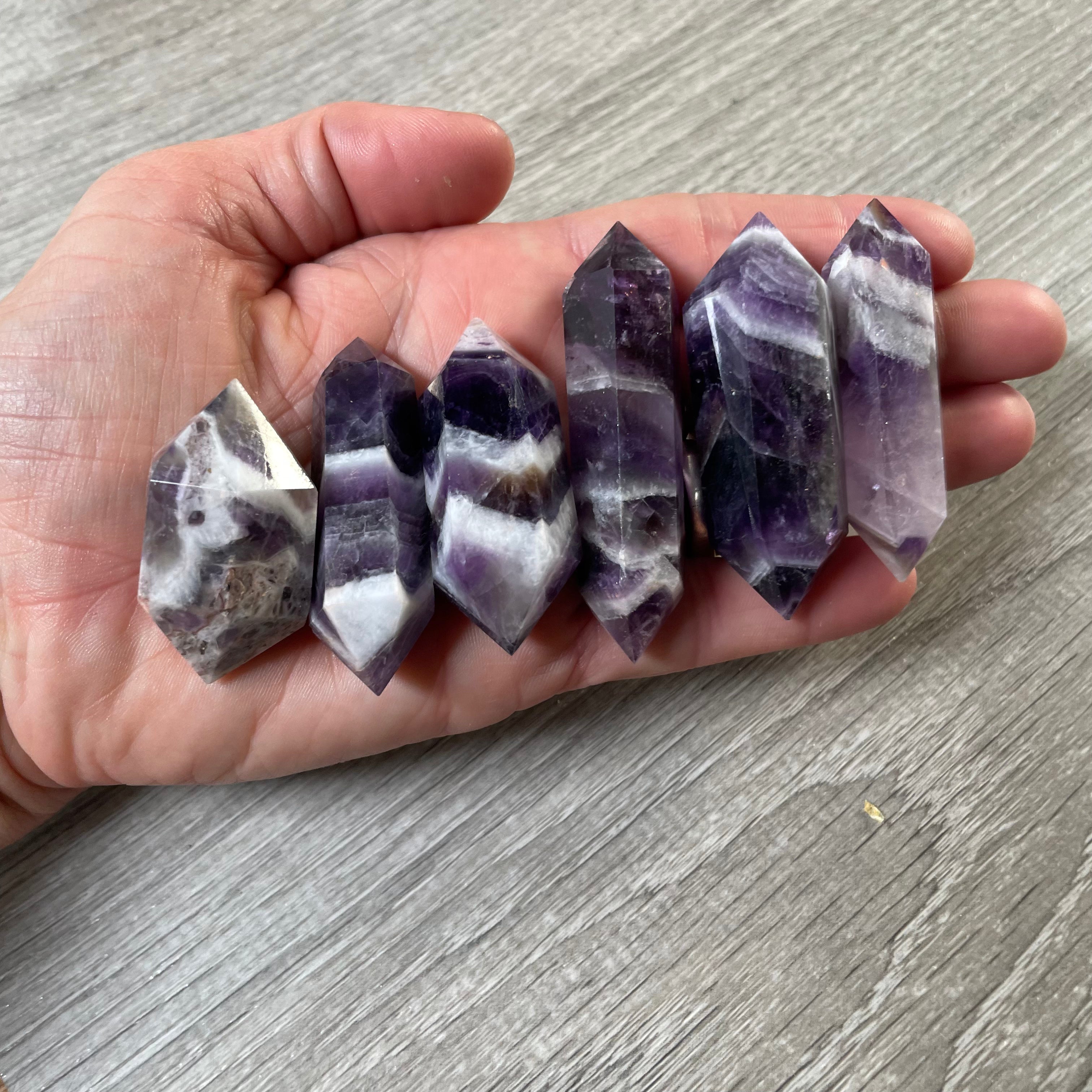 Amethyst gemstone wands showing their double pointed shape and surface patterns