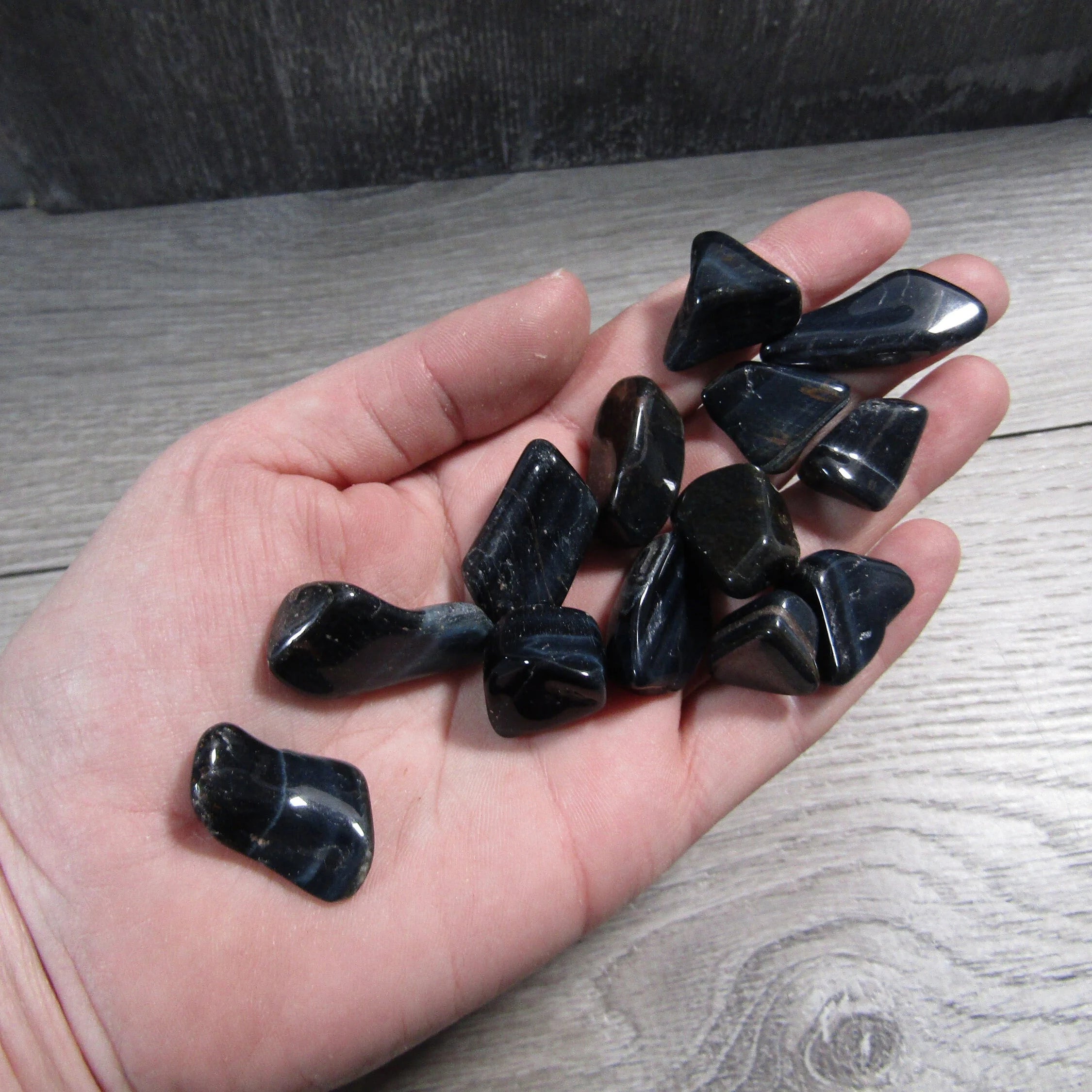 Tumbled Hawk’s Eye gemstone with dark blue shimmer