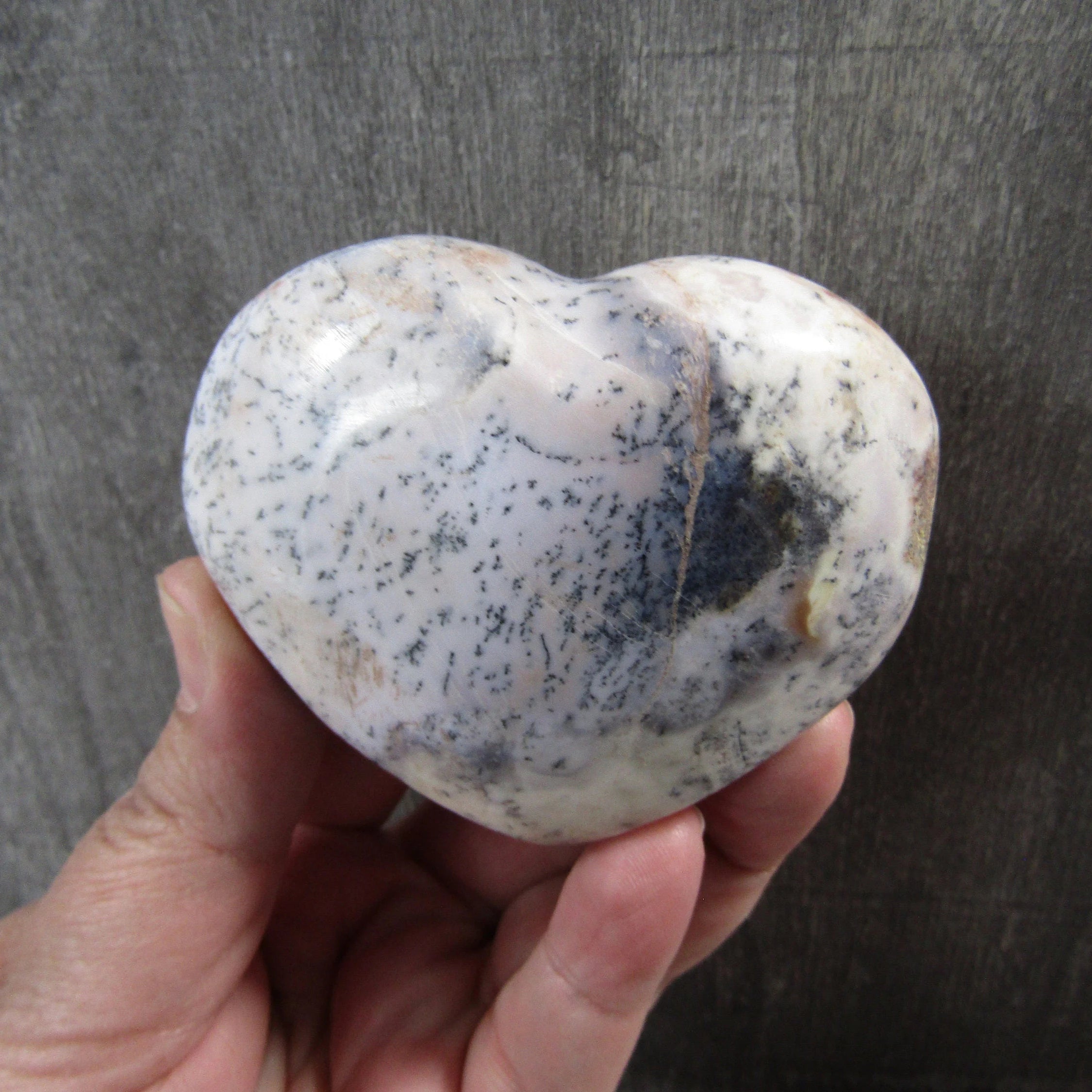 Metaphysical dendritic opal heart gemstone for resale