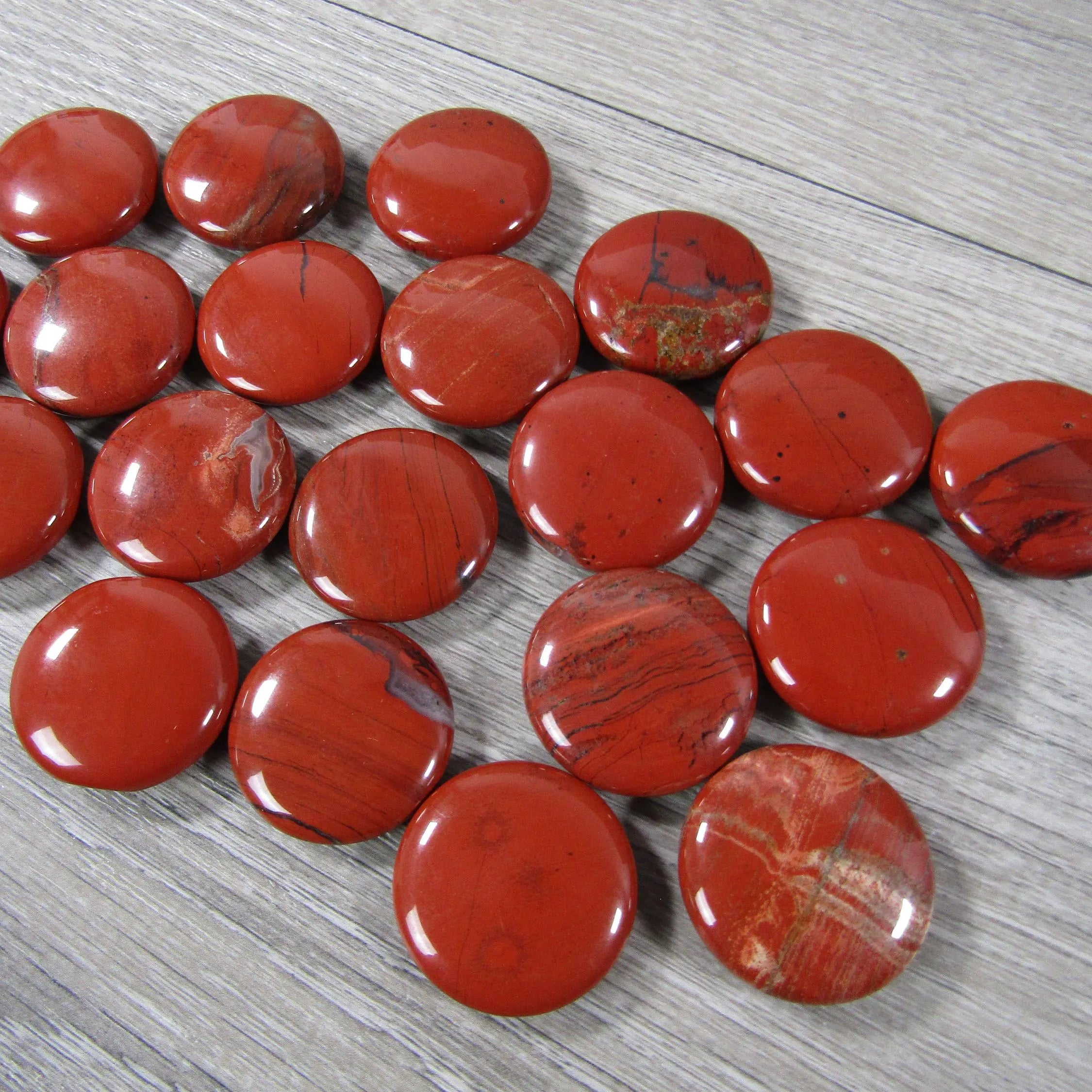Round red jasper flat gemstone disk for base chakra alignment