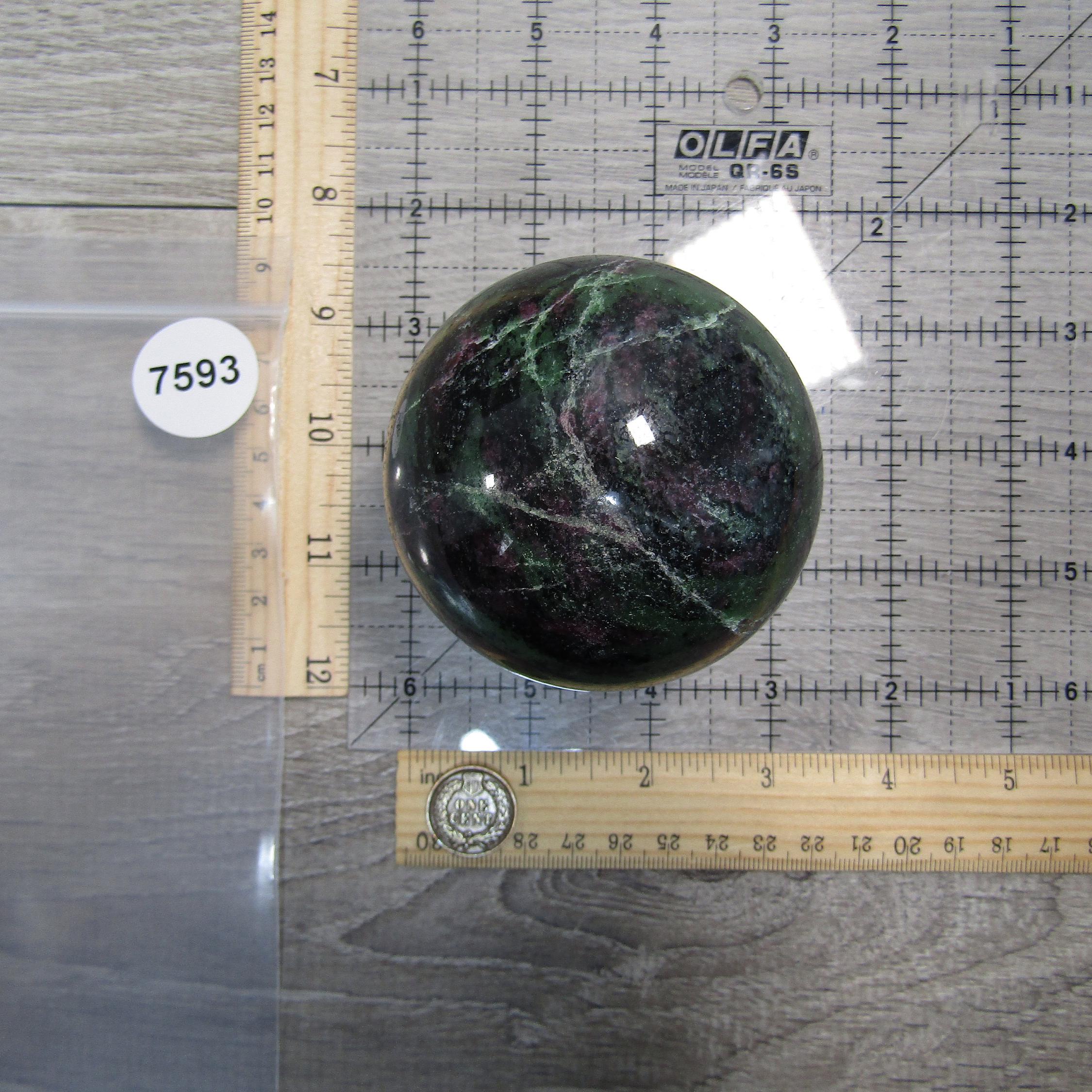Ruby zoisite decorative display sphere in retail setting