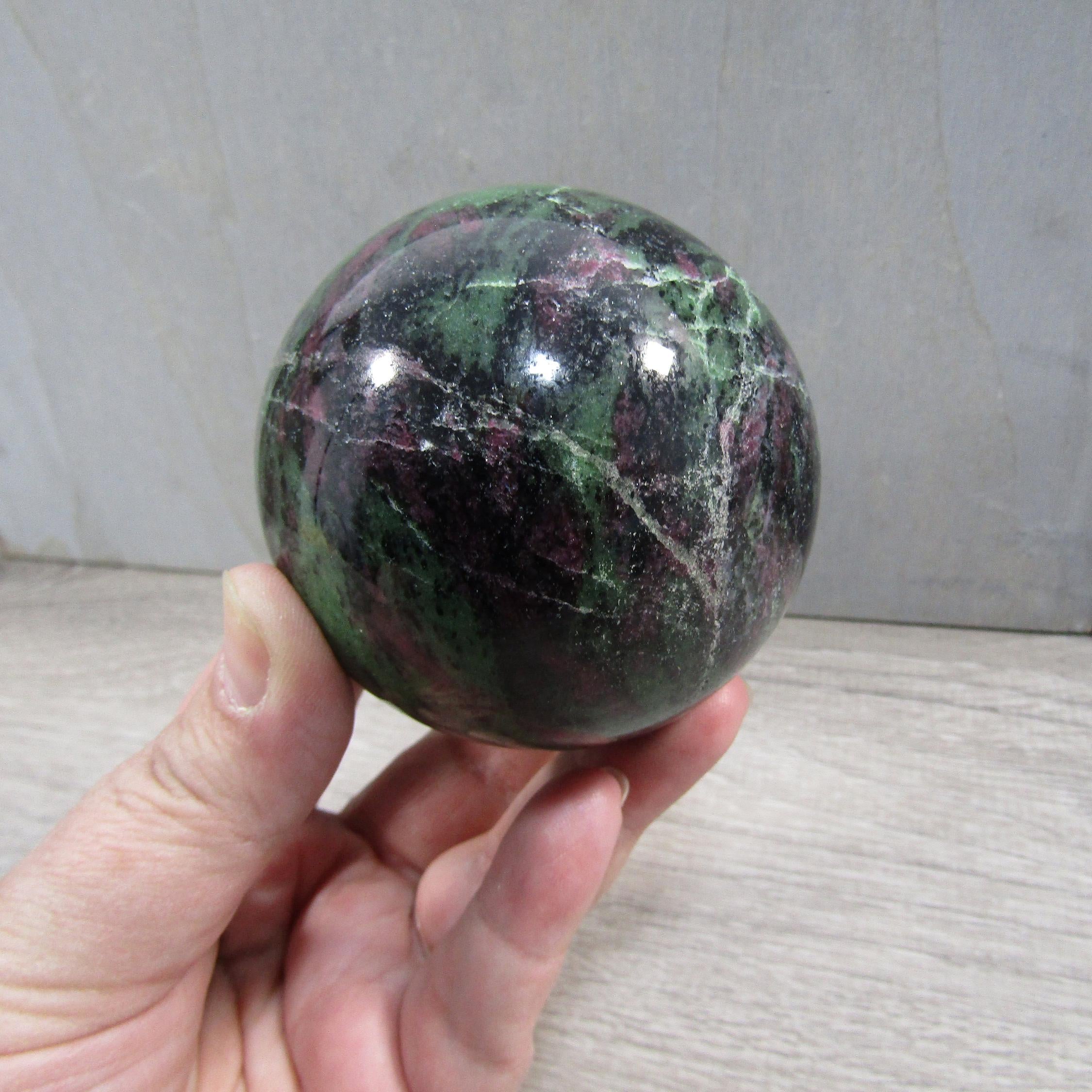 Hand-polished ruby zoisite crystal sphere for resale