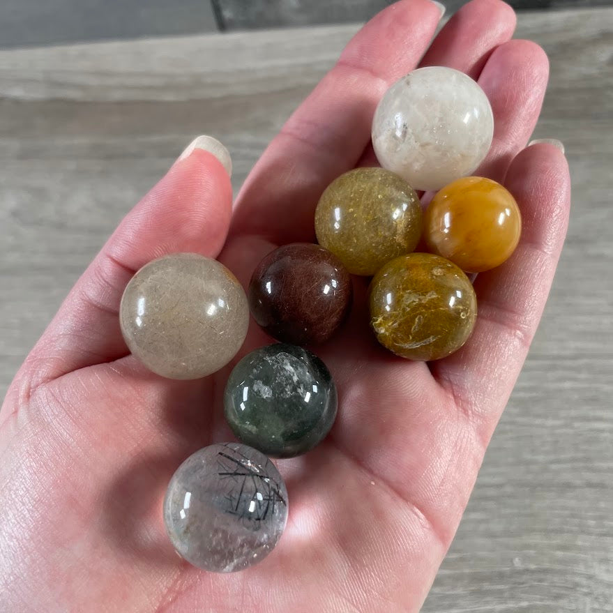 Assorted lodalite garden quartz and rutilated quartz spheres wholesale gemstone collection