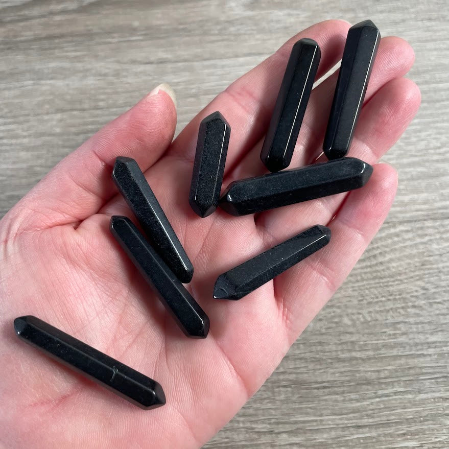 Natural Brazilian obsidian gemstone points with polished double terminated ends.