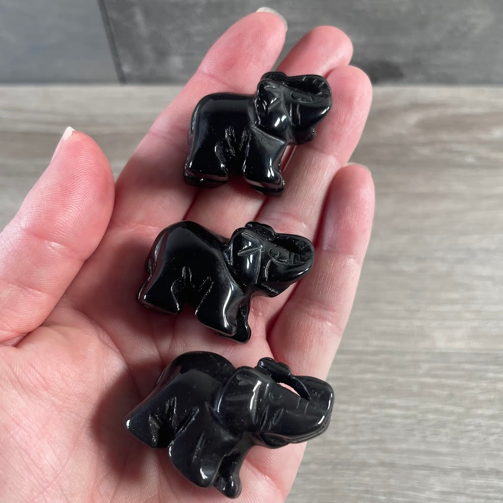 Obsidian gemstone elephant figurines featuring polished crystal animal carvings for wholesale