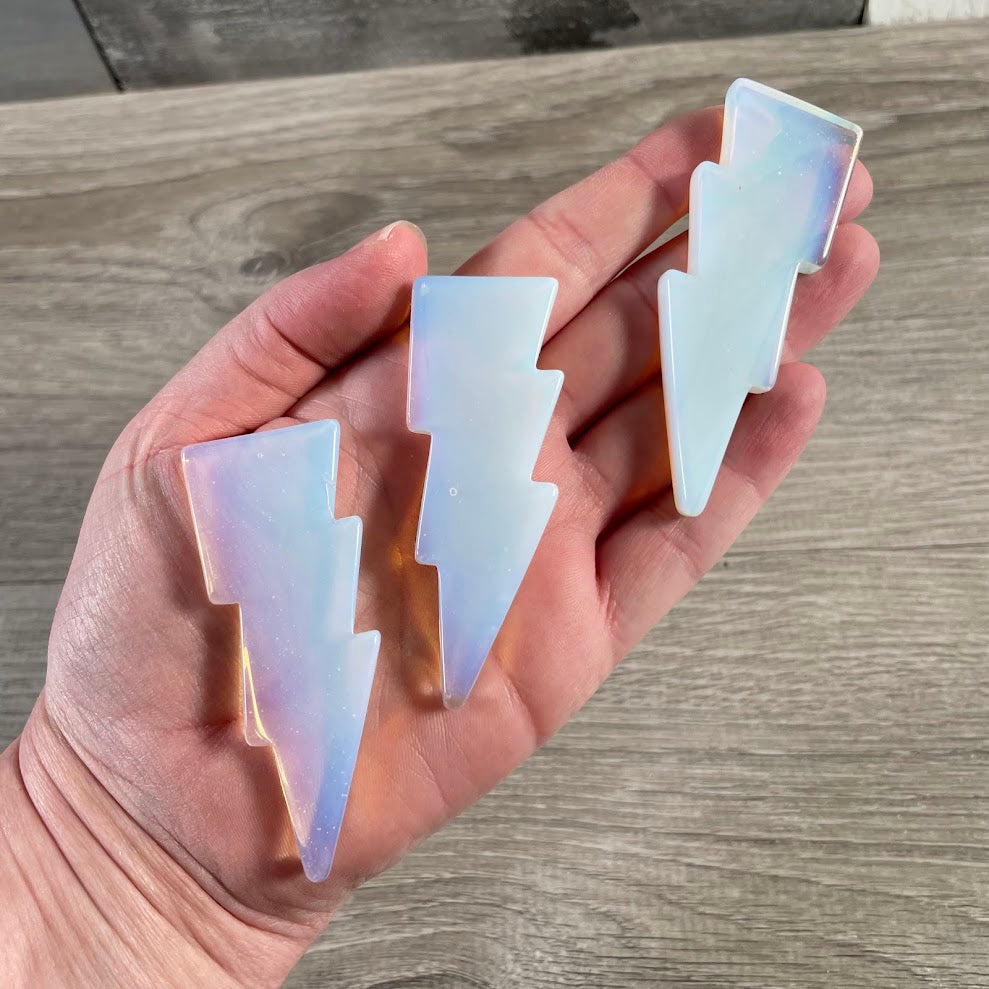 Opalite polished lightning bolt crystal carvings displayed as decorative gemstone gifts