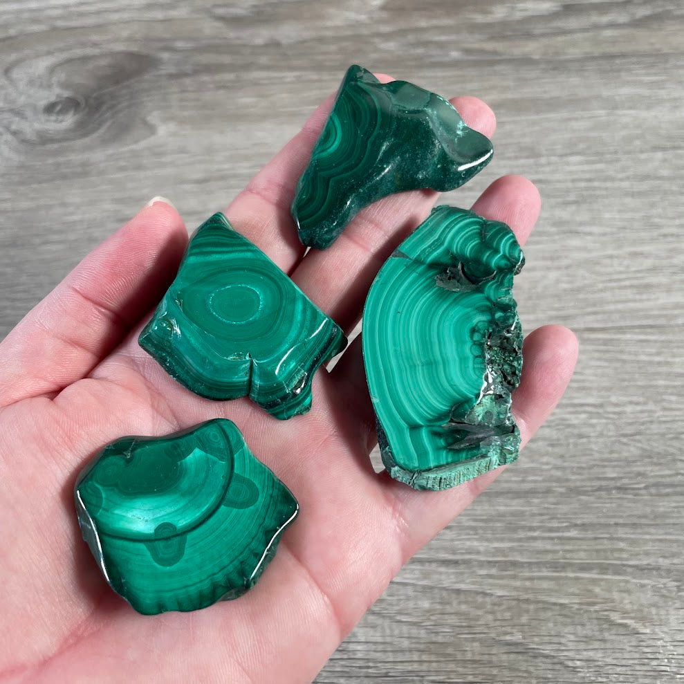 Malachite crystal slab with unique green swirls and natural mineral patterns