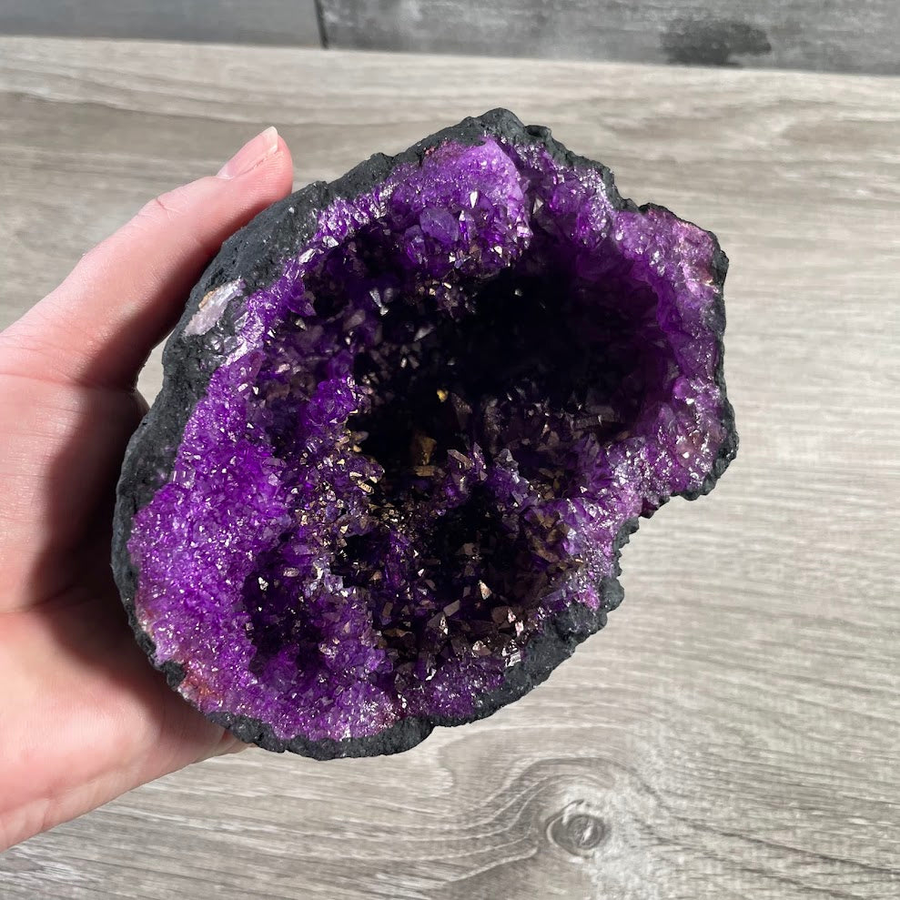 Decorative dyed geode halve with natural crystal formations for retail crystal displays