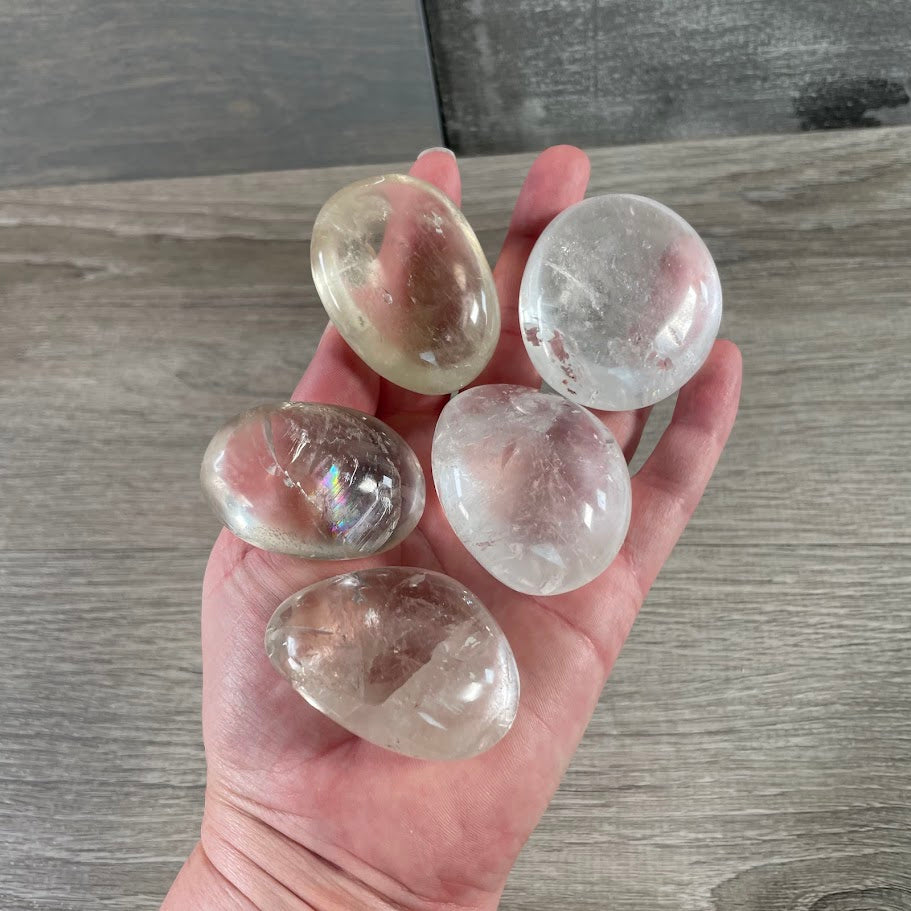 quartz gemstone palm stones displaying natural inclusions, colors, and polished finishes