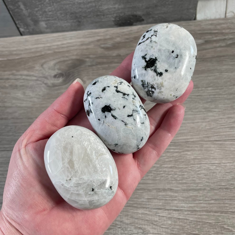 Polished Rainbow Moonstone oval palm stones with natural patterns and flash