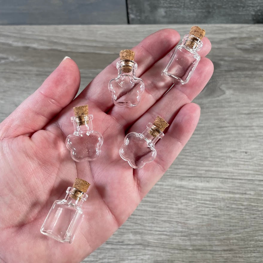 Small glass perfume and essential oil bottles with cork lids