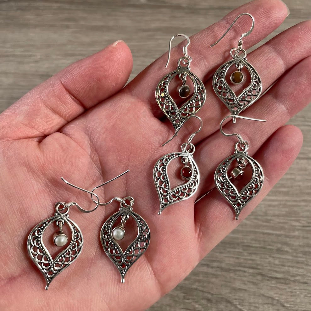 Wholesale sterling silver earrings featuring colorful assorted gemstones and dangling designs