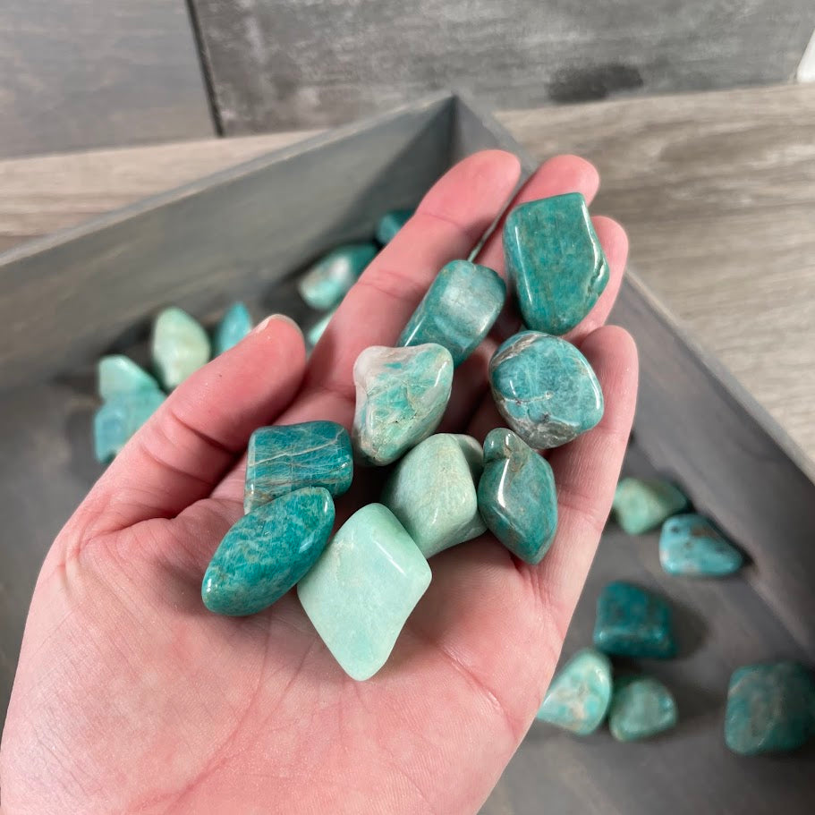 Wholesale amazonite tumbled stones in a 1 lb bulk lot featuring natural polished blue-green crystals for gemstone retailers