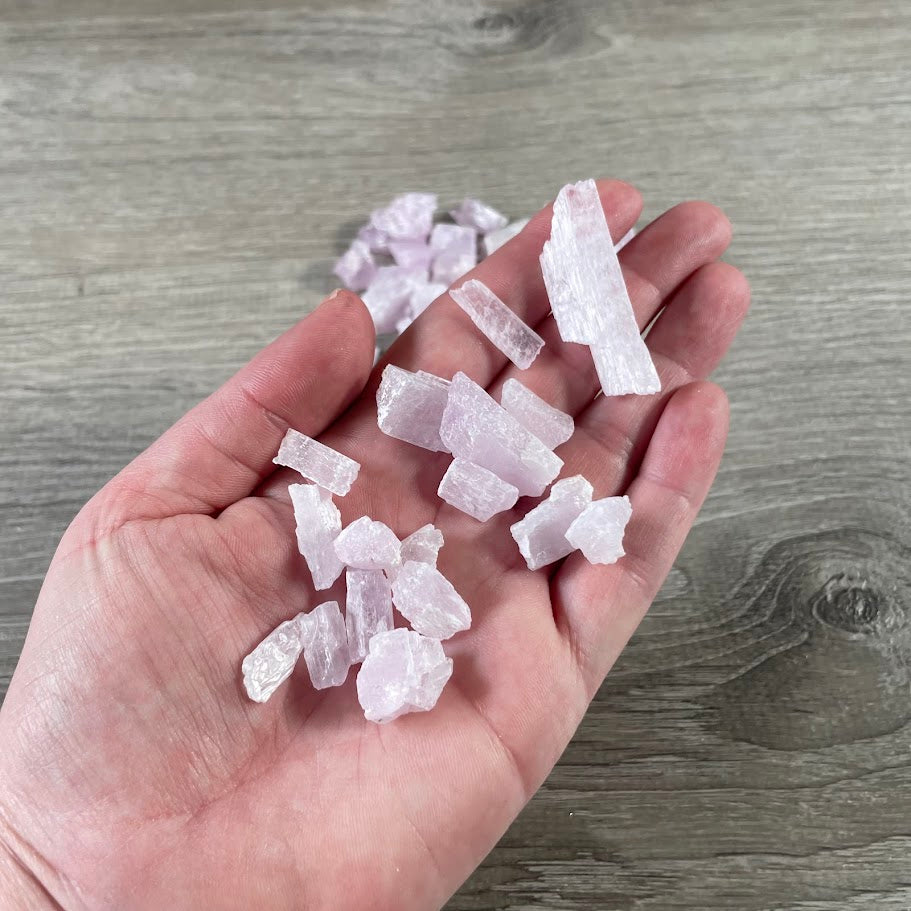 Wholesale raw kunzite crystals in a 4oz bag of natural rough gemstones