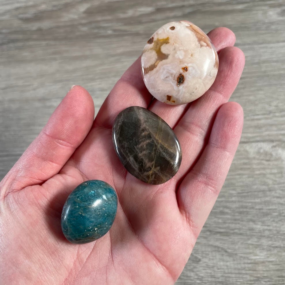 Wholesale polished palm stones in assorted crystal varieties for resale and retail displays