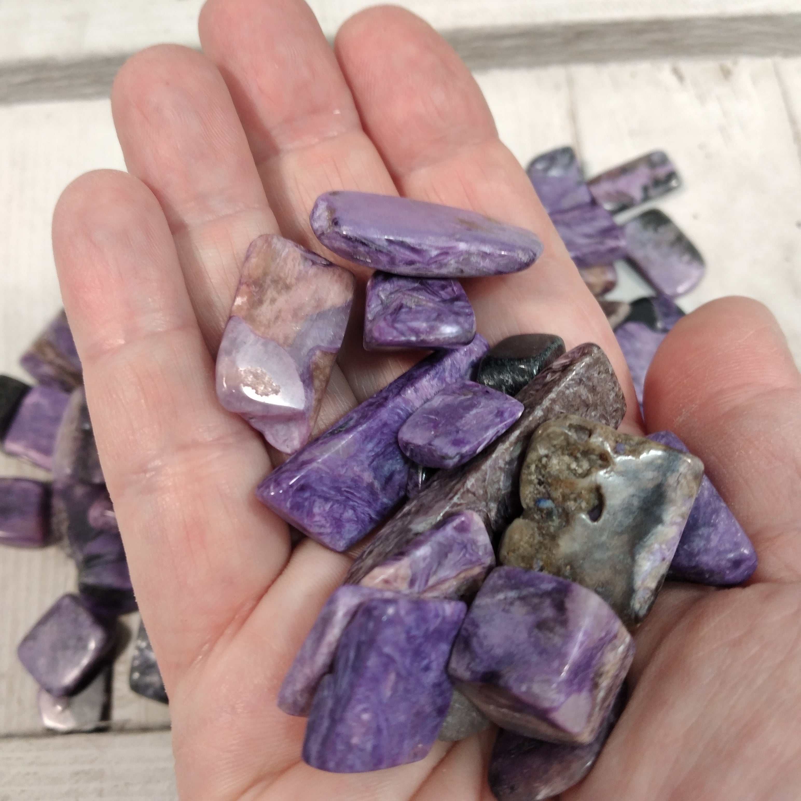 Wholesale bulk tumbled Charoite for spiritual use.