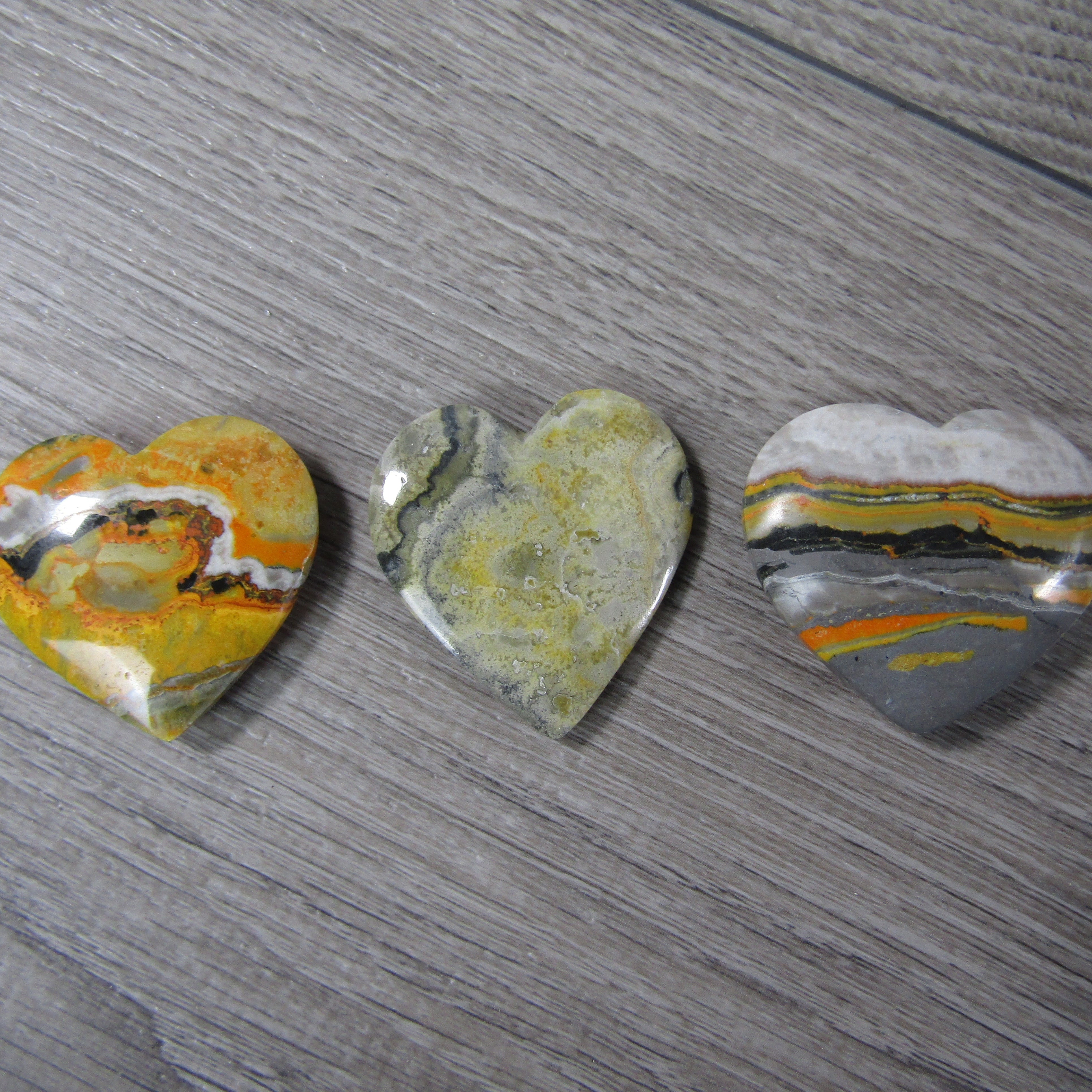 Hand-carved Bumble Bee Jasper heart gemstone for energy work and decor.