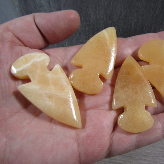 orange calcite natural stone arrowhead polished in bulk