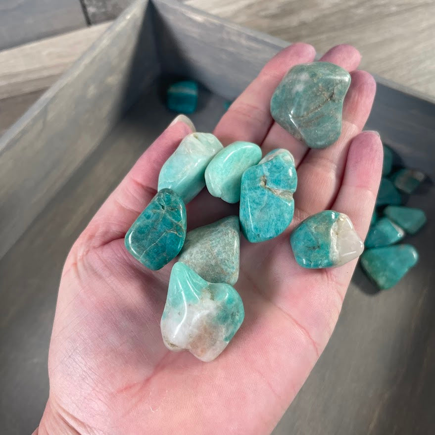 Polished Amazonite tumbled gemstones showing natural aqua green colors and white mineral patterns