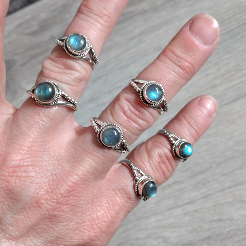 Sterling Silver Ring with a medium size band and a twisted setting and a round labradorite center stone