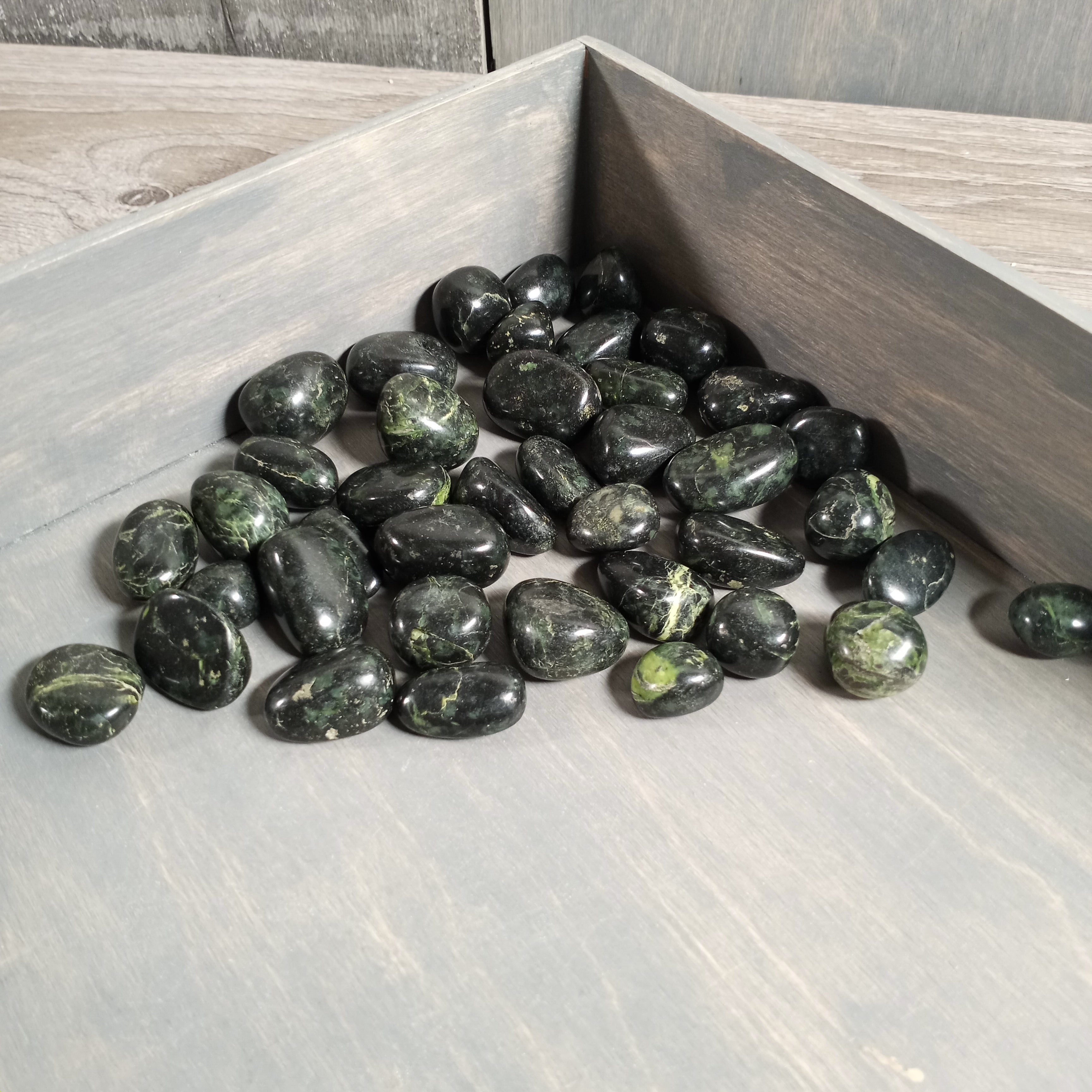 Tumbled Black Nephrite Jade stones for wholesale resale.