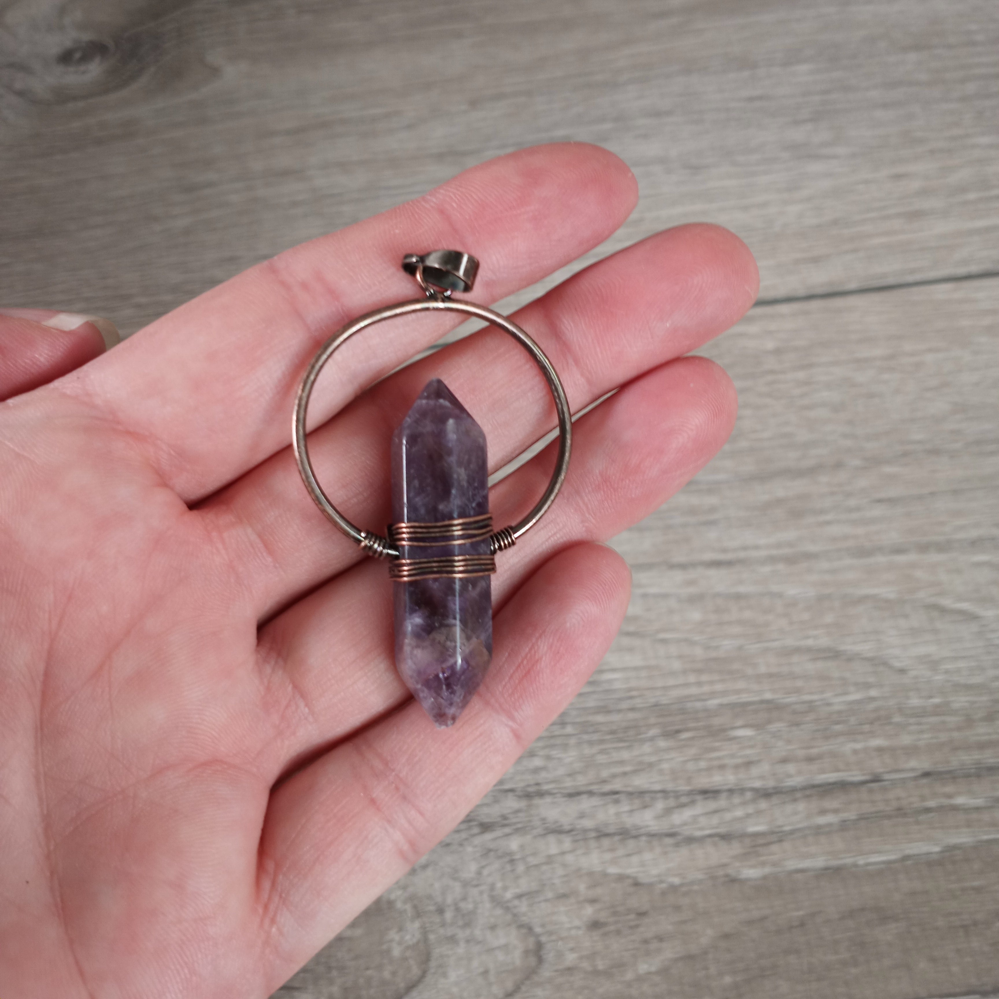 amethyst double terminated pendant with a bronze color metal 