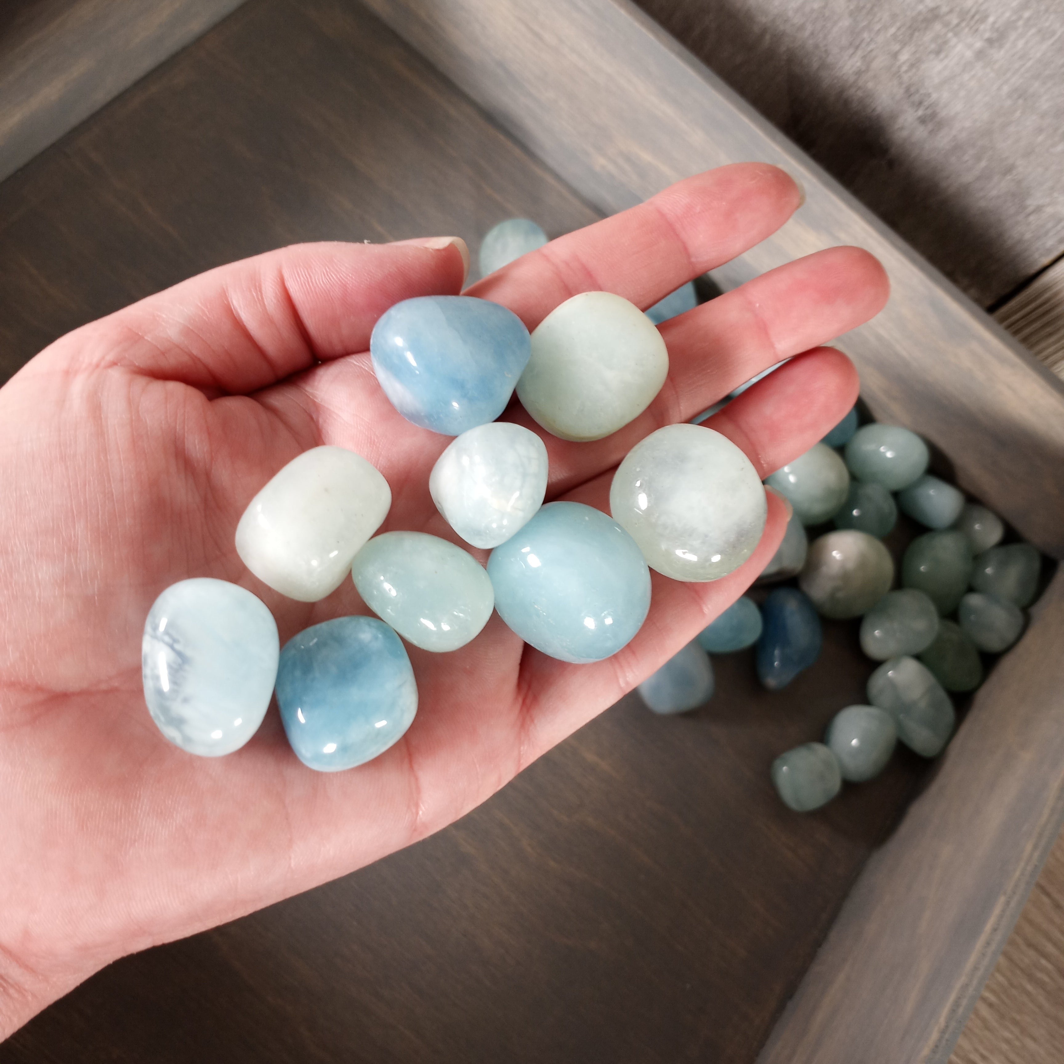 Aquamarine tumbled stones in bulk, polished and sold by the pound.