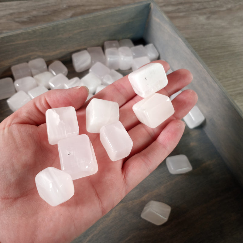 Tumbled Pink Mangano Calcite stones in cubic form, ideal for healing and decor, sold in bulk