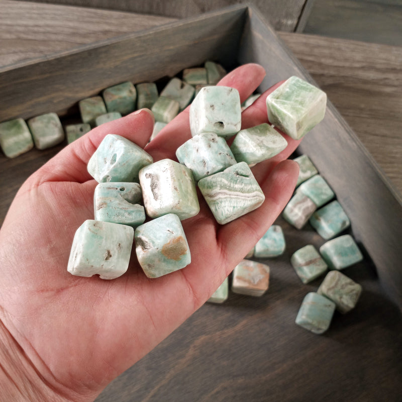 tumbled stones on display with vibrant blue and white patterns