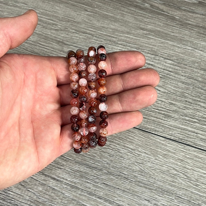 Stretchy bracelet made from 6mm round red gum flower agate beads