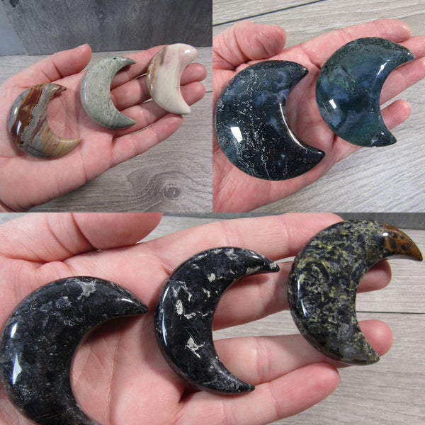 Hand holding a medium crescent moon crystal in Jasper, Moss Agate, or Picasso Jasper shown by stone in different hands