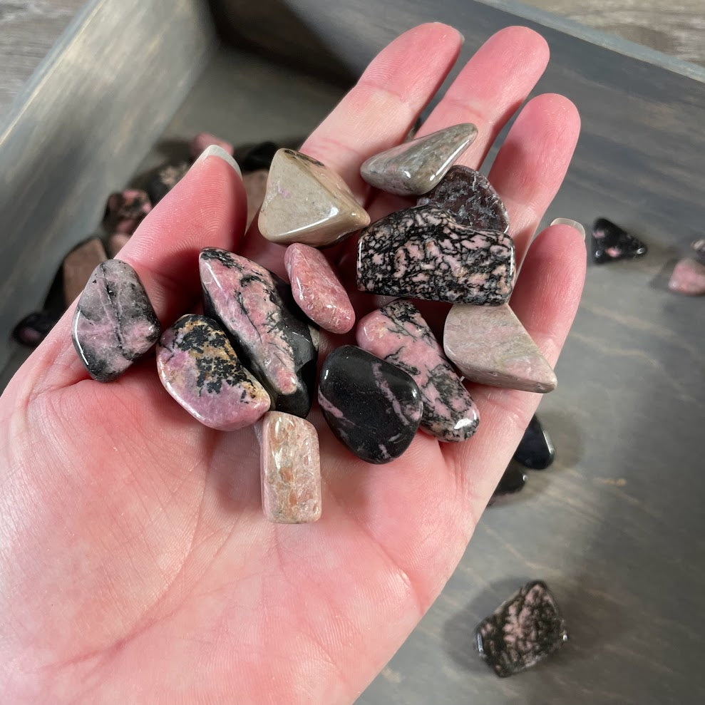 Pink and black rhodonite tumbled crystals for metaphysical and rock shops