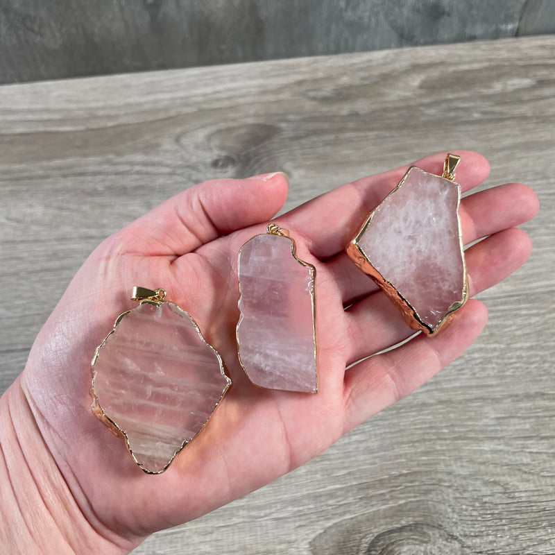 Rose quartz pendant with modern electroplated edging, perfect for retail shops.