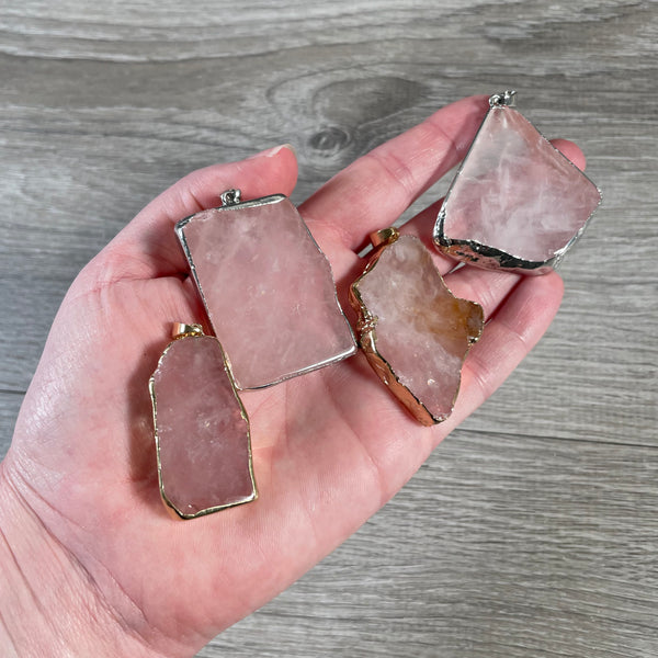 Assorted rose quartz electroplated pendants displayed for wholesale purchase