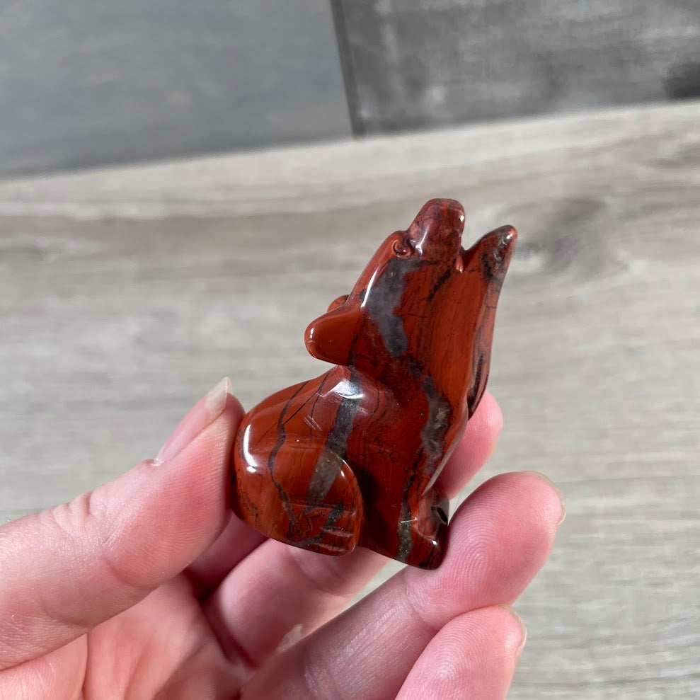 Carved crystal coyote statue with natural stone pattern for retail gemstone displays