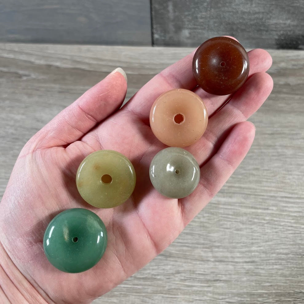 Wholesale gemstone donut stones in mixed colors and sizes for metaphysical and crystal displays