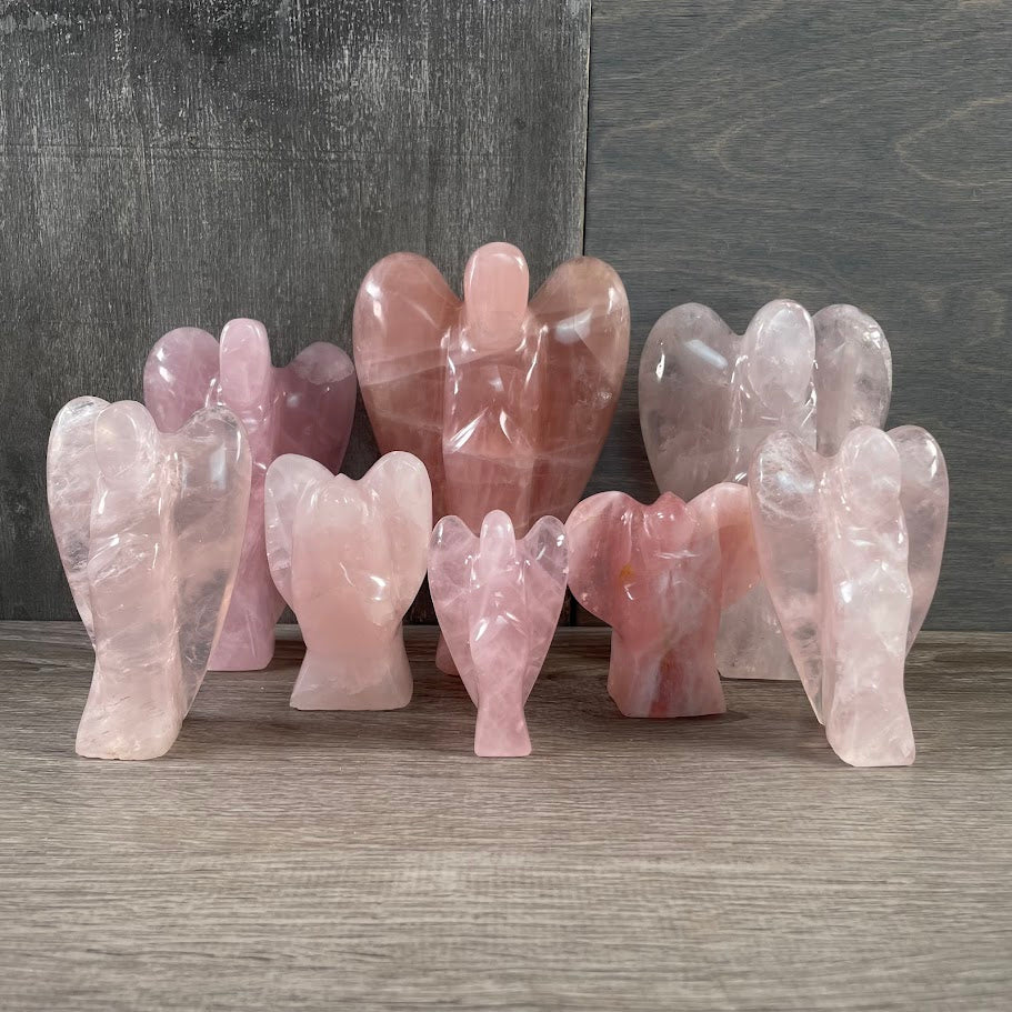 Lot of 8 rose quartz angels standing facing forward.