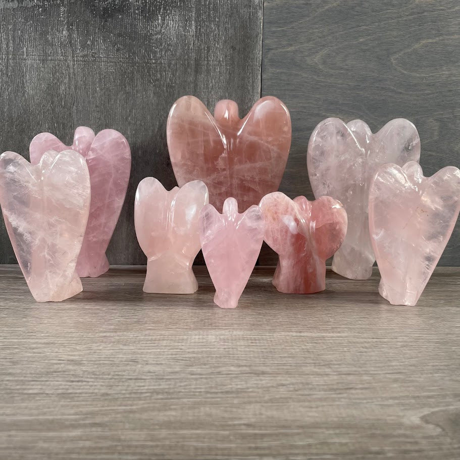 Lot of 8 rose quartz angels standing facing backwards.