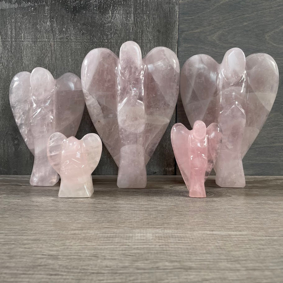 Lot of 5 rose quartz angels standing facing forward.