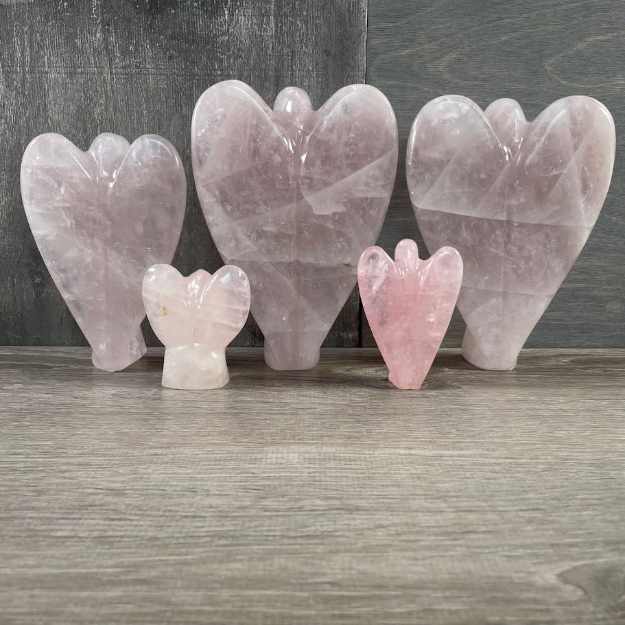 Lot of 5 rose quartz angels standing facing backwards. 