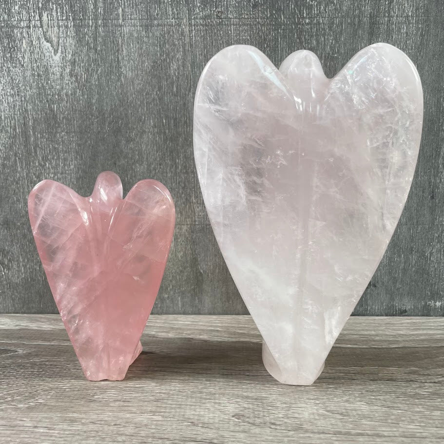 Lot of 2 rose quartz angels, standing facing backwards.