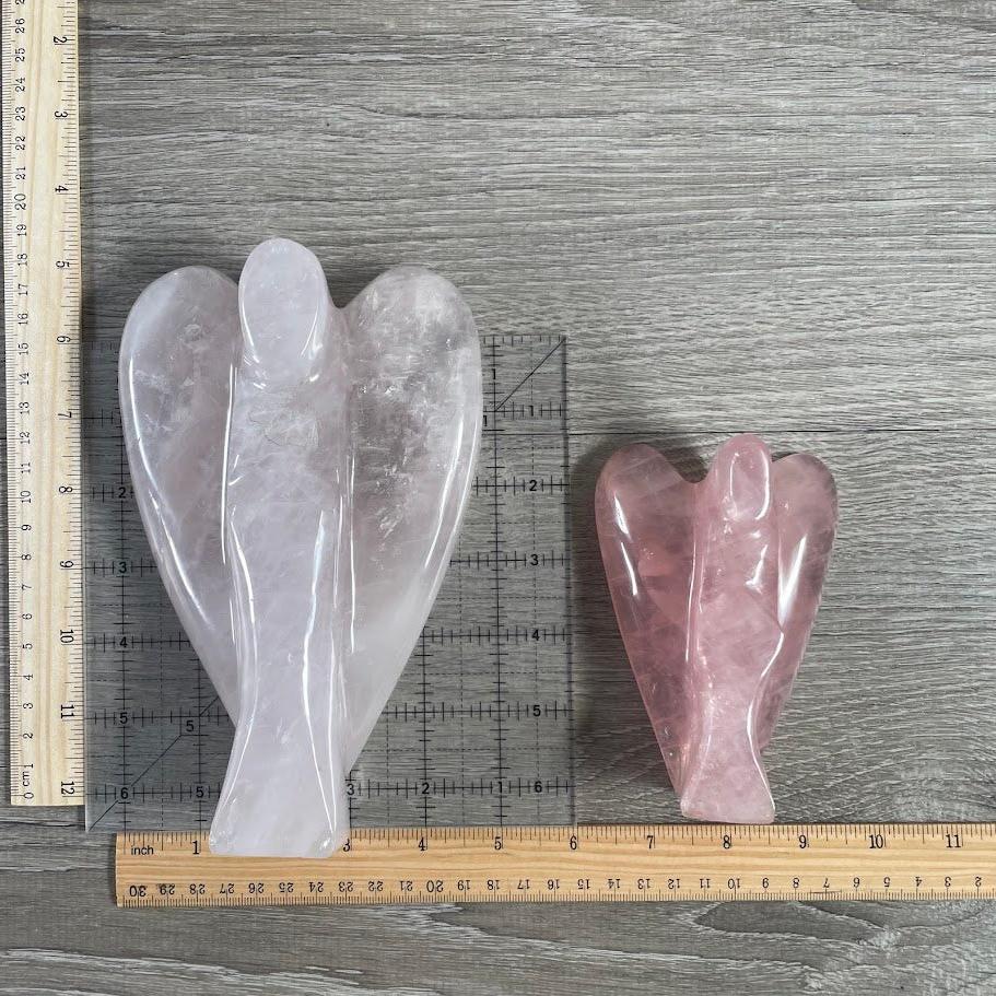 Lot of 2 rose quartz angels next to size reference.