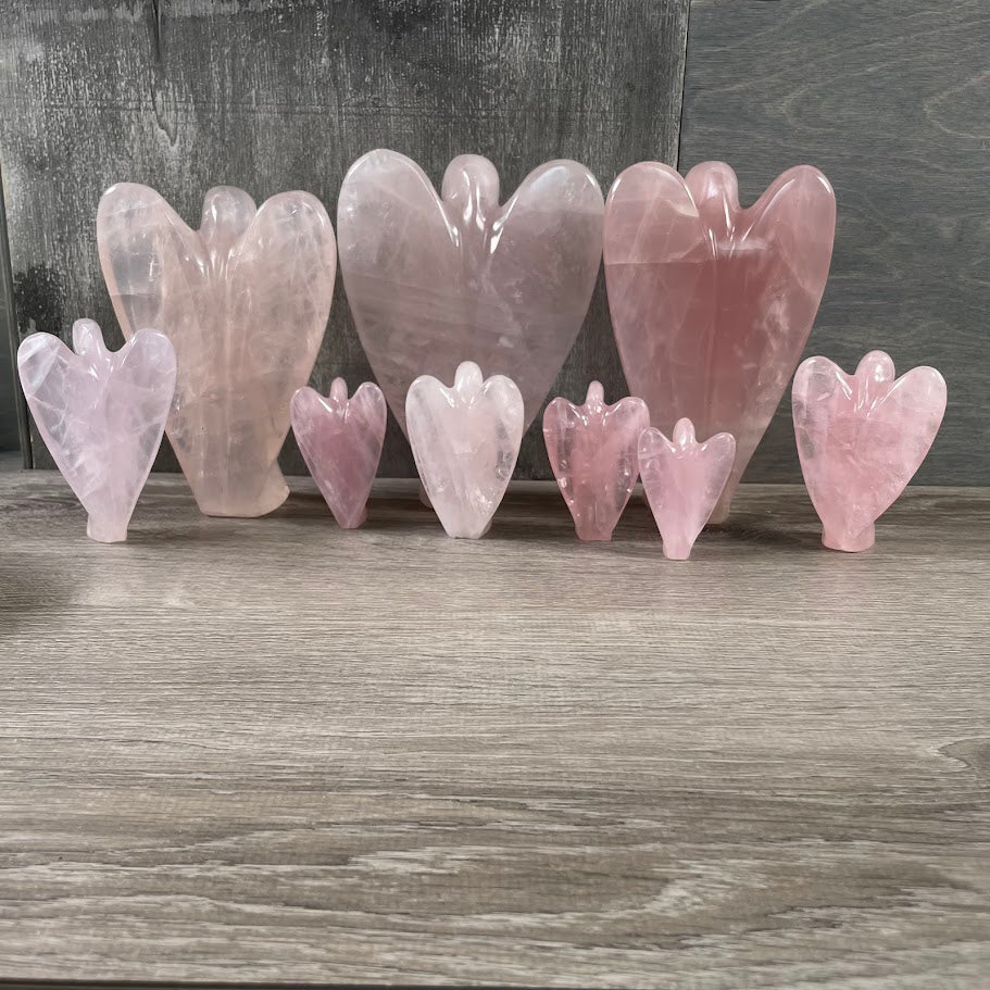 Lot of 9 rose quartz angels (3 large), standing facing backwards. 