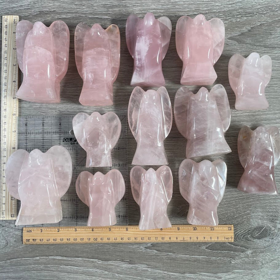 Lot of 13 stocky rose quartz angels next to size reference. 